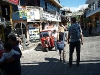 A small street in Guatemala full of signs in English. How does this affect a sustainable development?